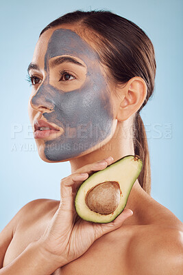 Buy stock photo Vision, avocado and mask for beauty with a woman in studio on a blue background for antiaging skincare. Face, facial and detox with an attractive young female holding a fruit for natural treatment