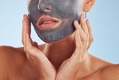 Buy stock photo Face mask, charcoal and beauty of woman with facial cosmetic treatment isolated in a blue studio background. Skin, skincare and young female person with clean, hydration and dermatology cream