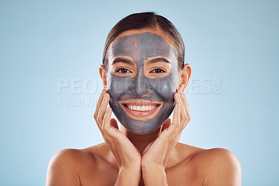 Buy stock photo Woman, charcoal and face mask for skincare, beauty and natural cosmetics cleaning product on studio, blue background. Portrait of person or model in facial collagen and mud skin care for dermatology