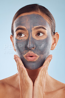 Buy stock photo Face mask, skincare and beauty of woman with cosmetic facial treatment isolated in a blue studio background. Skin, charcoal and young female person with clean, hydration and dermatology cream