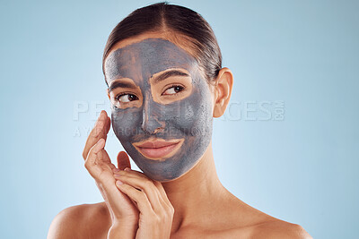 Buy stock photo Clay face mask, skincare and woman with beauty in studio isolated on blue background. Cosmetics, model and natural facial treatment for peeling to exfoliate skin, dermatology or cleaning for wellness