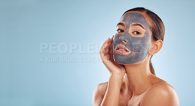 Buy stock photo Charcoal face mask, skincare and woman with beauty in studio on banner or blue background mockup space. Cosmetics, serious model and portrait in facial treatment for peeling, dermatology or cleaning