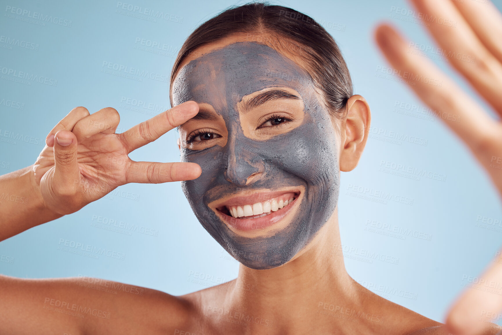 Buy stock photo Woman, face mask and selfie in charcoal skincare and facial profile picture on studio blue background. Photography, peace and v sign of beauty influencer or person portrait, collagen and dermatology