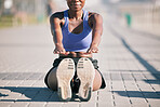 Sports woman, legs and stretching to touch feet for fitness, training and performance on urban ground. Closeup, female athlete and warm up for workout, muscle mobility and flexible exercise of runner