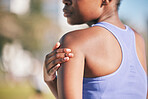 Arm, pain and black woman with injury in outdoor with training accident from sport with exercise. Runner, shoulder and muscle strain with female athlete after workout at park for cardio for wellness.