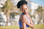 Injury, arm and pain with black woman in outdoor from sport with fitness from training accident or joint problem. Shoulder, pain and female athlete with muscle and strain after workout for cardio.