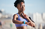 Sports, workout and woman checking her pulse with smartwatch for running outdoor in nature. Fitness, exercise and African female athlete monitoring heart rate for cardio training for race or marathon