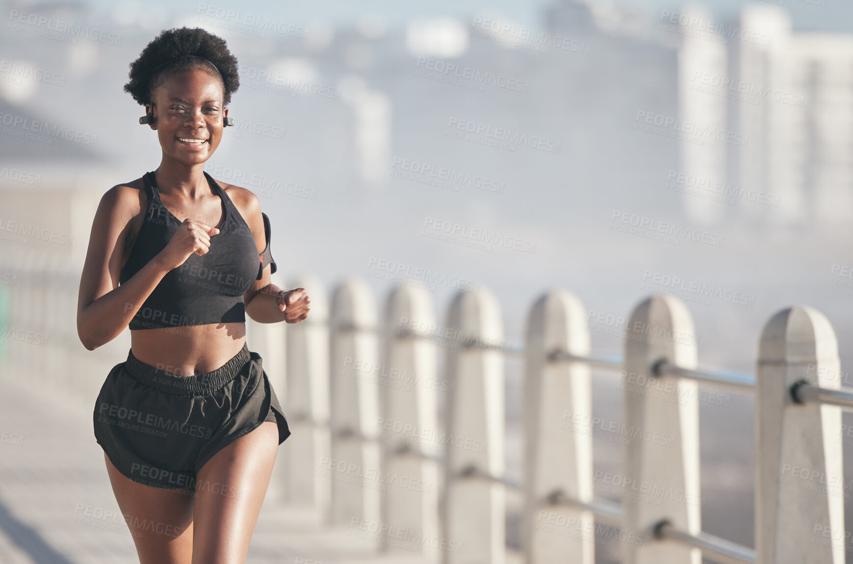 Buy stock photo Sports, running and black woman outdoor with music earphones for audio, radio sound and podcast. Smile, fitness and happy African athlete training, workout and exercise for health, wellness or cardio