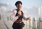 Portrait, running and black woman outdoor with music earphones for audio, radio and podcast. Sports, fitness and happy African athlete training, workout and exercise for health, wellness and cardio