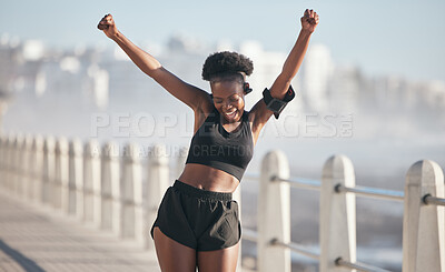 Buy stock photo Happy woman, dance and fitness success by city beach in energy, exercise and cardio health with music technology. Listening, training and celebration, winning or yes of african person or runner goals