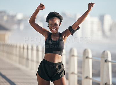 Buy stock photo Dance, fitness and portrait of woman by city beach for energy, exercise and cardio health with music technology. Listening, training and celebration, winning or yes of African person or runner goals