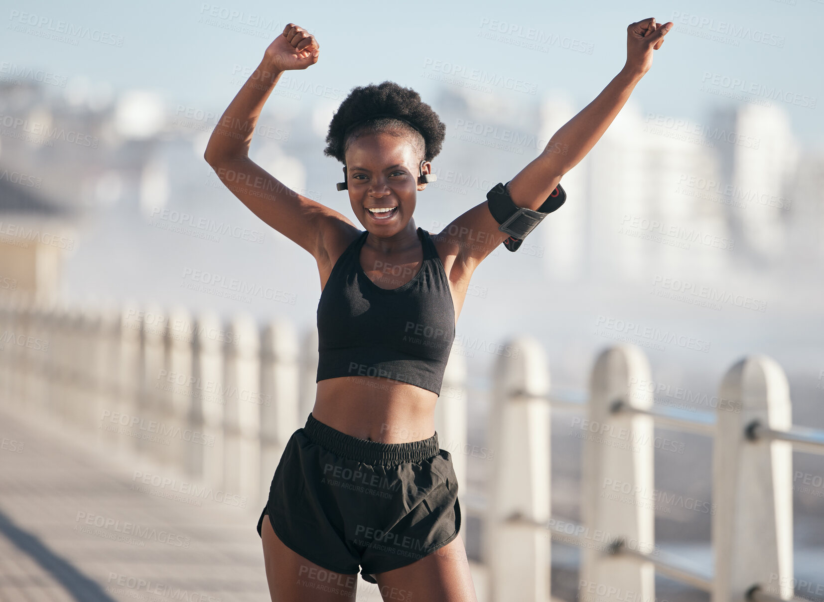 Buy stock photo Dance, fitness and portrait of woman by city beach for energy, exercise and cardio health with music technology. Listening, training and celebration, winning or yes of African person or runner goals