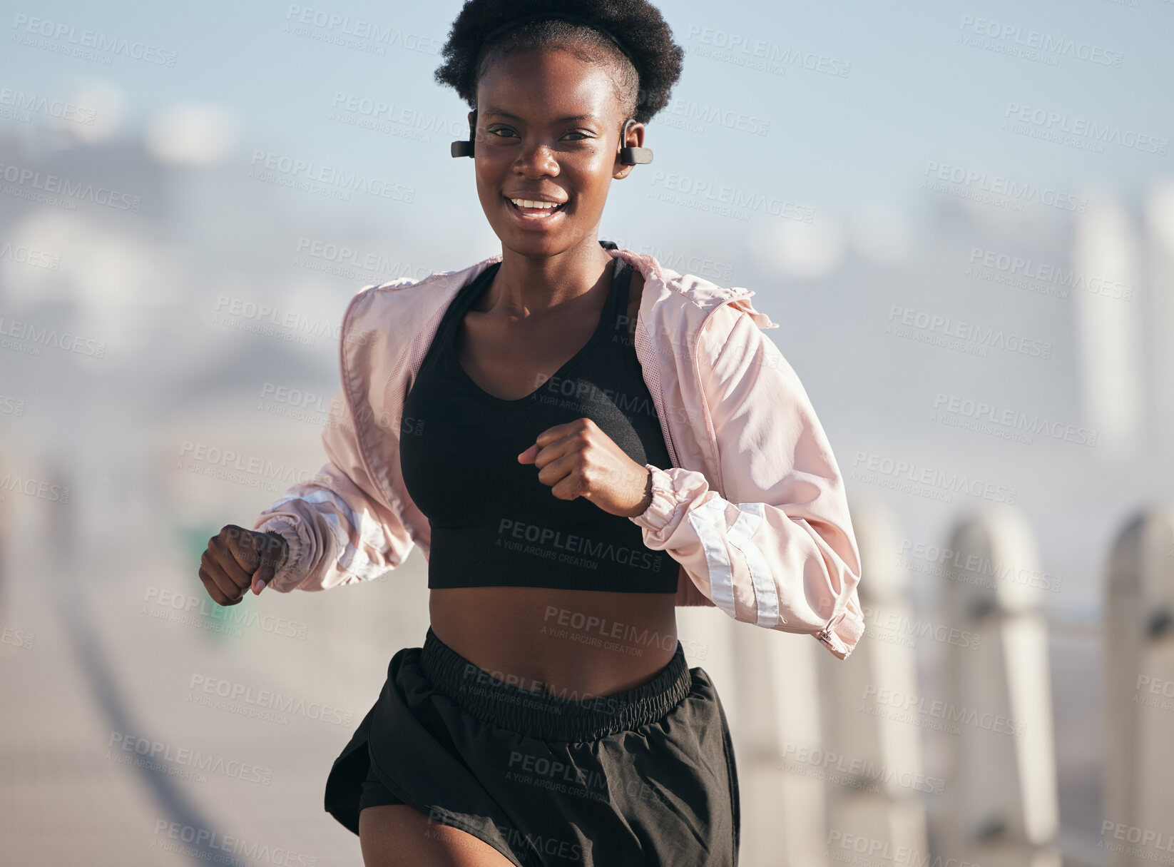 Buy stock photo Portrait, running and black woman outdoor with earphones for audio, radio music and podcast. Sports, fitness and happy African athlete training, workout and exercise for health, wellness and cardio