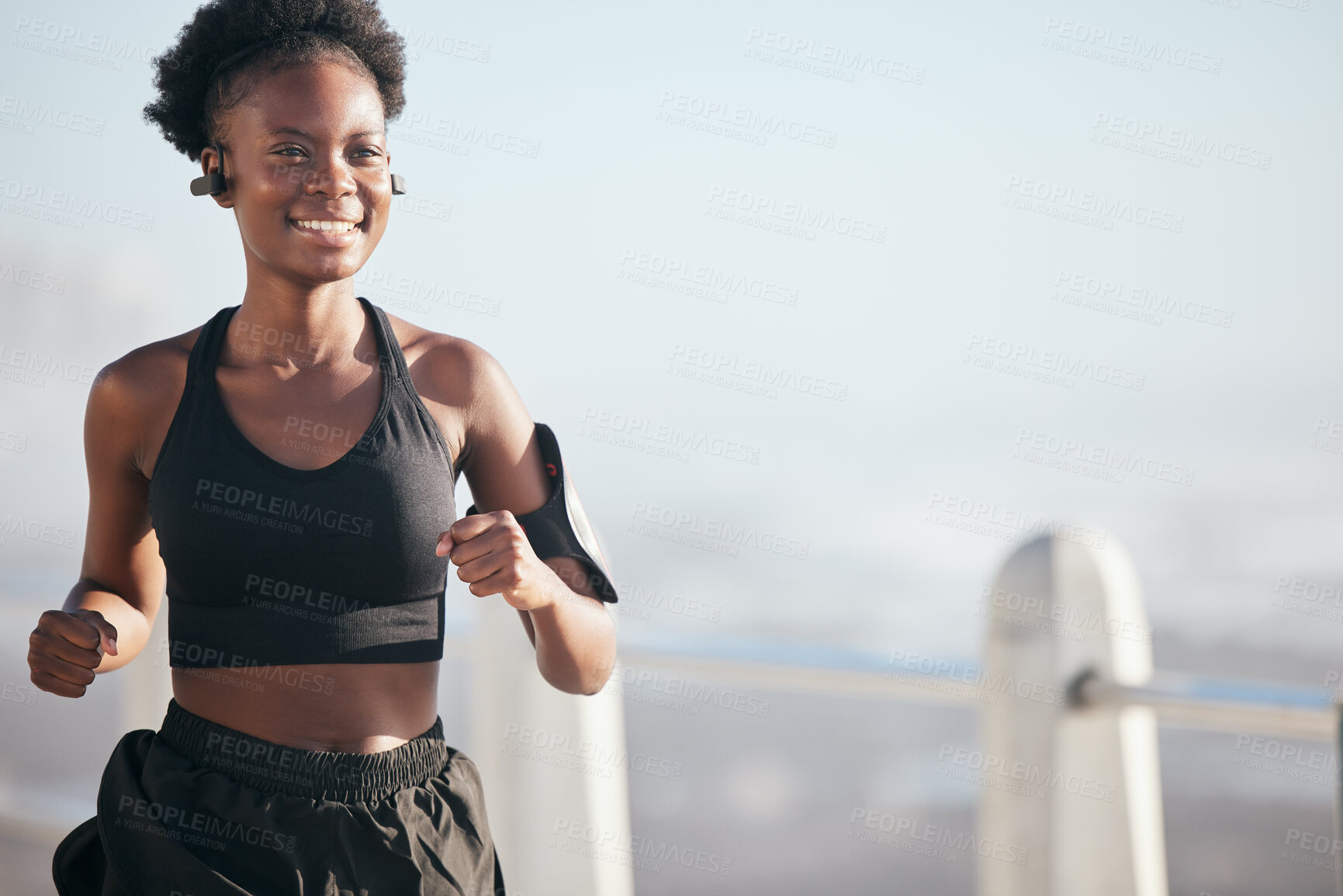 Buy stock photo Smile, running and black woman outdoor with music earphones for radio, podcast and mockup space. Sports, fitness and happy African athlete training, workout or exercise for health, wellness or cardio