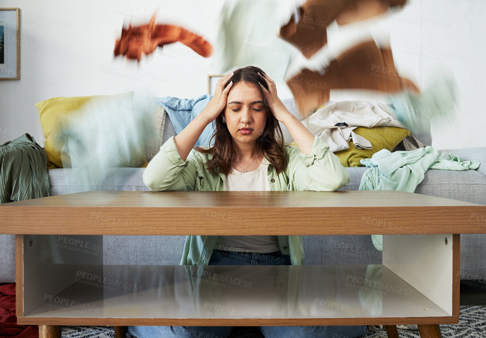 Buy stock photo Headache, stress and woman with anxiety for laundry, clothes or overwhelmed by cleaning task. Housework, burnout and lady with migraine for washing, pile or chaos at home with vertigo or brain fog