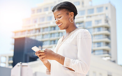 Buy stock photo Phone, city and commute with a business black woman typing a text message while walking to work outdoor. Mobile, social media or networking and a happy female employee in an urban town with flare