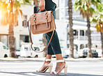 Fashion, travel and a woman waiting for a taxi on a sidewalk in the city during her morning commute. Legs, bag or high heels and a female tourist in an urban town for transportation with flare