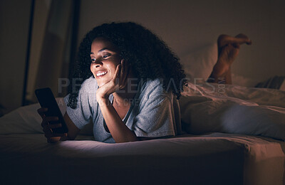 Buy stock photo Happy woman, phone and relax in bed at night for social media, online browsing or streaming at home. Female person smile on mobile smartphone app in the dark late evening for entertainment in bedroom