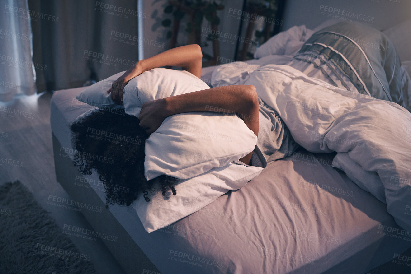 Buy stock photo Bedroom, insomnia and woman with pillow on face, tired and frustrated with stress, nightmare or dream. Fatigue, sleep problem and exhausted girl in bed with fear, scared at night and crisis in home.