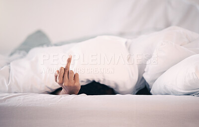 Buy stock photo Angry, hand and person with insomnia in bed with a middle finger for morning or waking up, sleeping in bedroom and at home. Hand, show a curse sign and frustrated with sleep problem at night