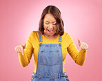 Excited, pointing and young woman in a studio for marketing, promotion or advertising. Shock, surprise and Asian female model with presentation or showing finger gesture isolated by a pink background