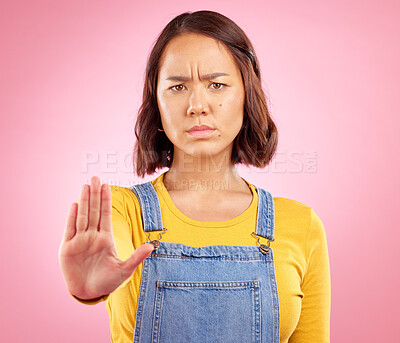 Buy stock photo Woman, hand and stop in studio portrait with angry face, rejection or bad review by pink background. Gen z student girl, icon or emoji for protest, voice or opinion for feedback, activism or warning