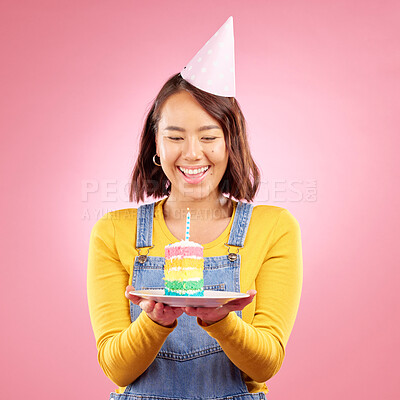 Buy stock photo Birthday cake candle, studio and happy Asian woman excited, smile and celebrate party, present or gift. Congratulations, wow and Japanese person with dessert, candy or sweets on pink background