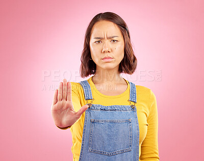 Buy stock photo Woman, palm and stop in studio portrait with angry face, rejection or bad review by pink background. Gen z student girl, sign or emoji for protest, voice or opinion for feedback, activism or warning