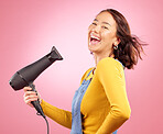 Hairdryer, funny and hair care with portrait of woman in studio for hairdresser, beauty and cosmetics. Shampoo, smile and hairstyle with person laughing on pink background for product, salon and glow