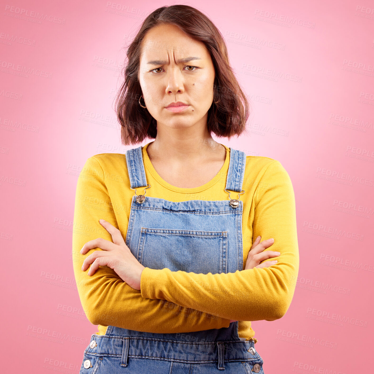 Buy stock photo Portrait, frown and angry asian woman with arms crossed in studio and defensive body language on pink background. Wtf, face and frustrated Japanese female disappointed by news, fail or mood isolated