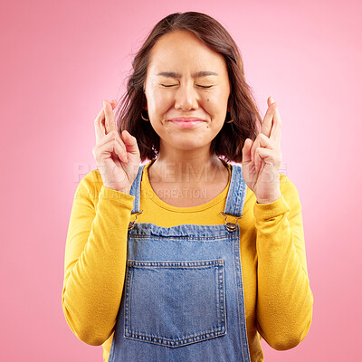 Buy stock photo Woman, fingers crossed and hope for success in studio, pink background or praying for good luck. Asian model, hands and wish for bonus, giveaway winner or emoji sign for competition prize in lottery