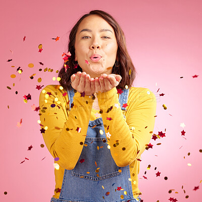 Buy stock photo Portrait, celebration and woman blow confetti to celebrate winner announcement, congratulations and New Years cheers. Studio, winning or Asian person happy for birthday party event on pink background