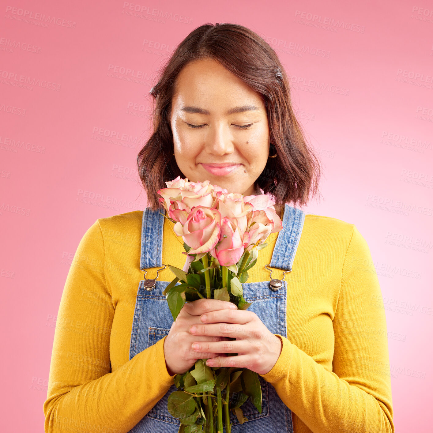 Buy stock photo Woman, smell roses and gift in studio, smile and excited for celebration, birthday or party by pink background. Japanese student girl, thinking and bouquet of flowers for present, reward or romance