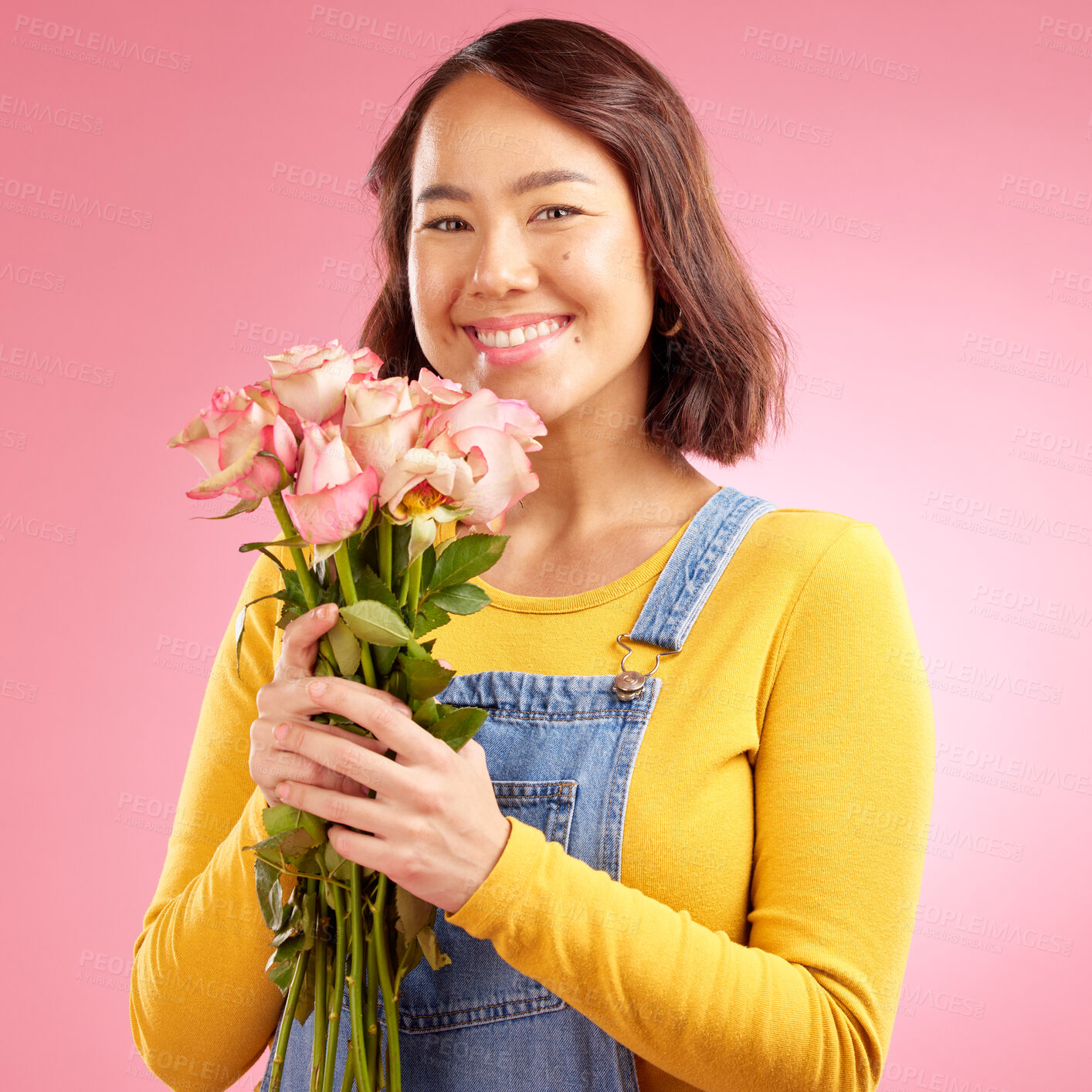 Buy stock photo Woman, roses and gift with smile in studio portrait for celebration, birthday or party by pink background. Japanese student girl, gen z fashion and bouquet of flowers for present, reward or romance