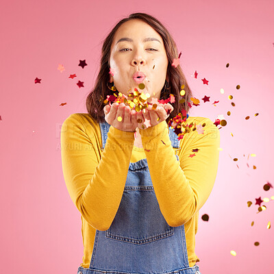 Buy stock photo Portrait, celebration and Asian woman blow confetti to celebrate winner, happiness and excited at party event. Studio color, wow and creative Japanese person happy for birthday on pink background