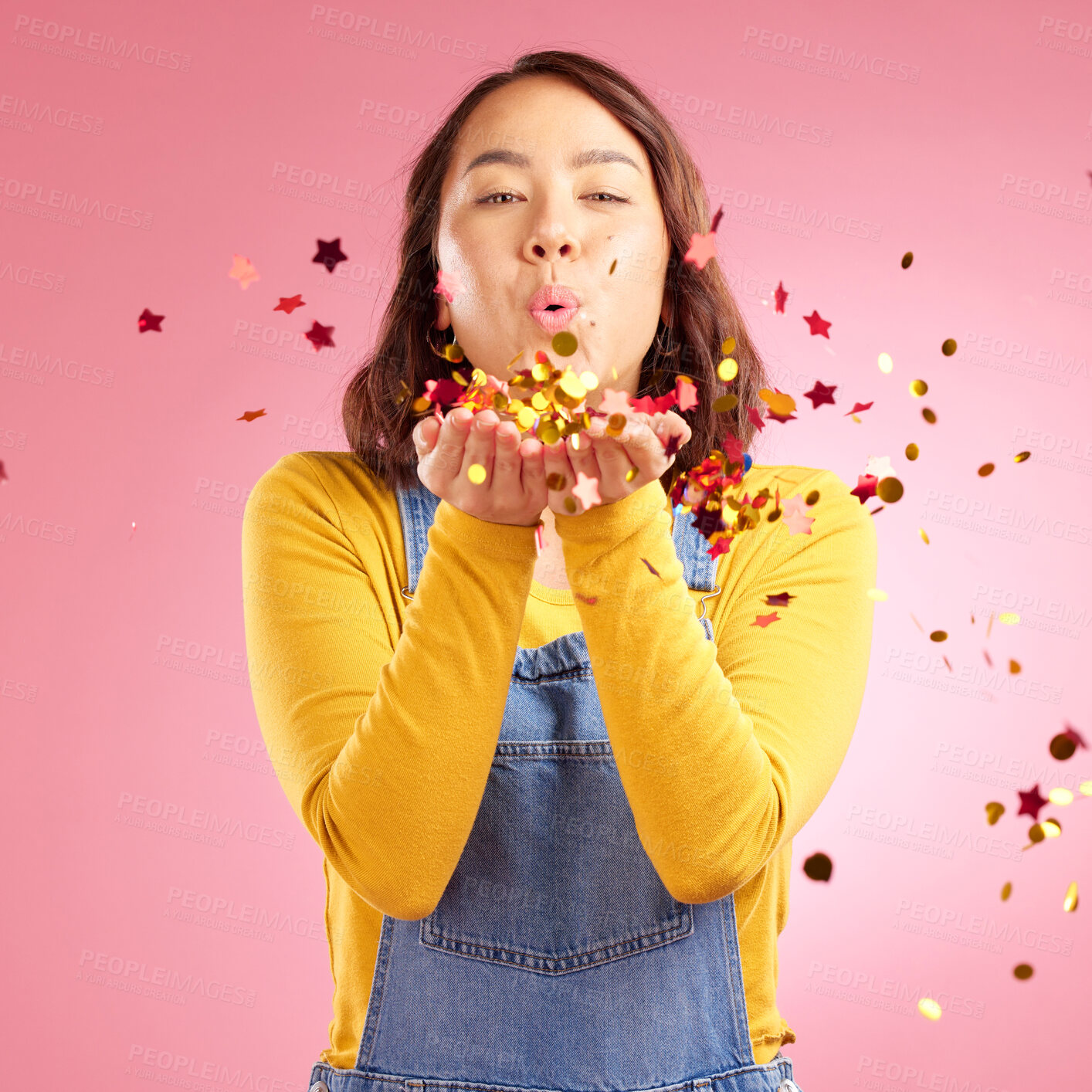 Buy stock photo Portrait, celebration and Asian woman blow confetti to celebrate winner, happiness and excited at party event. Studio color, wow and creative Japanese person happy for birthday on pink background