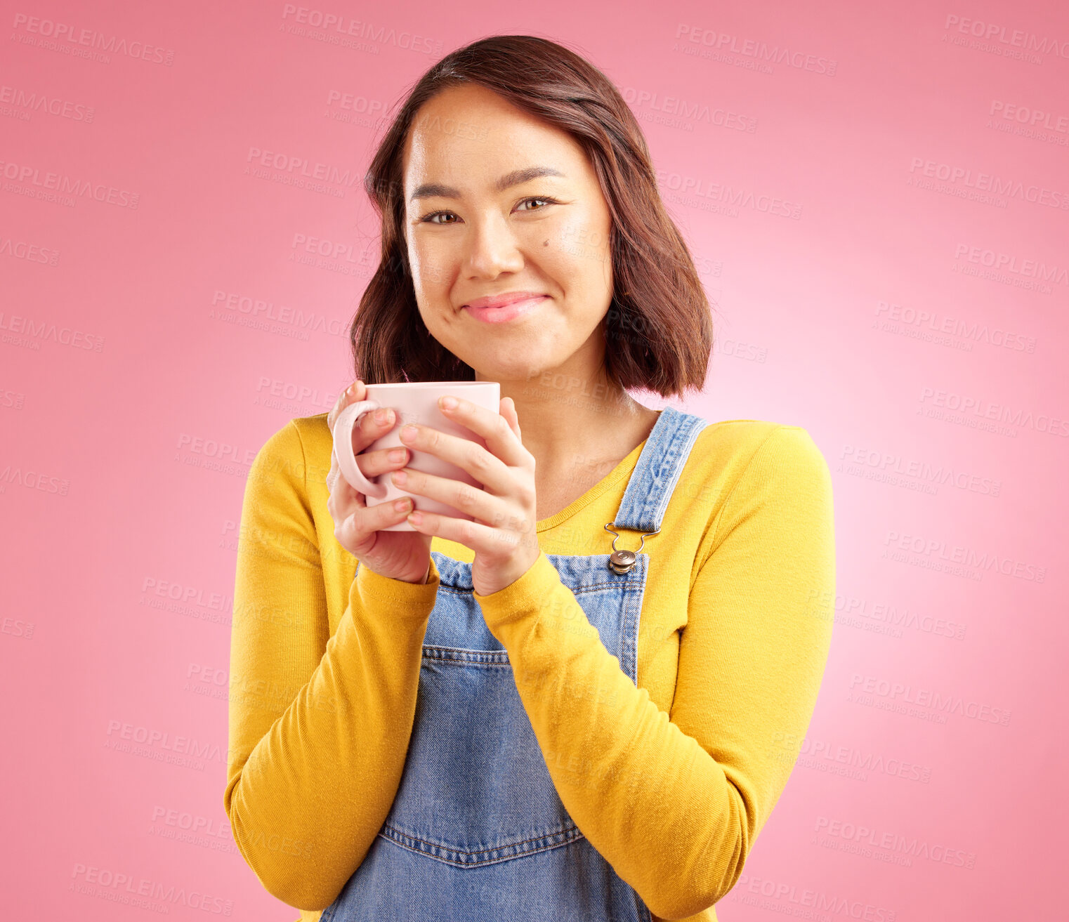 Buy stock photo Woman, coffee and smile in studio portrait with hand holding hot drink for energy by pink background. Japanese student, gen z girl and happy for matcha, espresso or latte with fashion, relax and cup