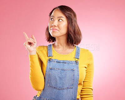 Buy stock photo Asian woman, smile and hand pointing to studio for news, announcement or coming soon deal on pink background. Finger, show and Japanese lady with timeline, checklist or sign up, promo or contact info