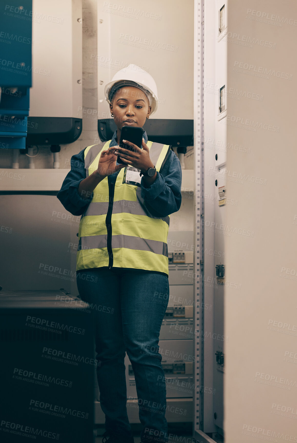 Buy stock photo Black woman, engineering and electrician on cellphone in control room for system maintenance, industrial mechanic and inspection. Female technician, mobile technology and planning electrical services