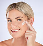 Skincare, face cream and portrait of woman in studio with natural, health and beauty facial routine. Wellness, self care and female model with face lotion, sunscreen or creme by a white background.