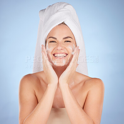 Buy stock photo Shower, portrait and woman washing face with soap in studio, blue background and cleaning cosmetics. Happy female model, facial skincare and foam for healthy glow, dermatology and moisturizing beauty