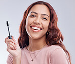 Portrait, beauty or happy girl with mascara makeup, cosmetics or product brush laughing in studio. Smile, face or woman model smiling with eyelashes tool for make up or self care on white background