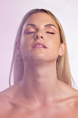 Buy stock photo Face, beauty and skincare with a model woman in studio on a gray background in ambient lighting for feminine desire. Luxury, makeup or cosmetics with a young person posing eyes closed for wellness