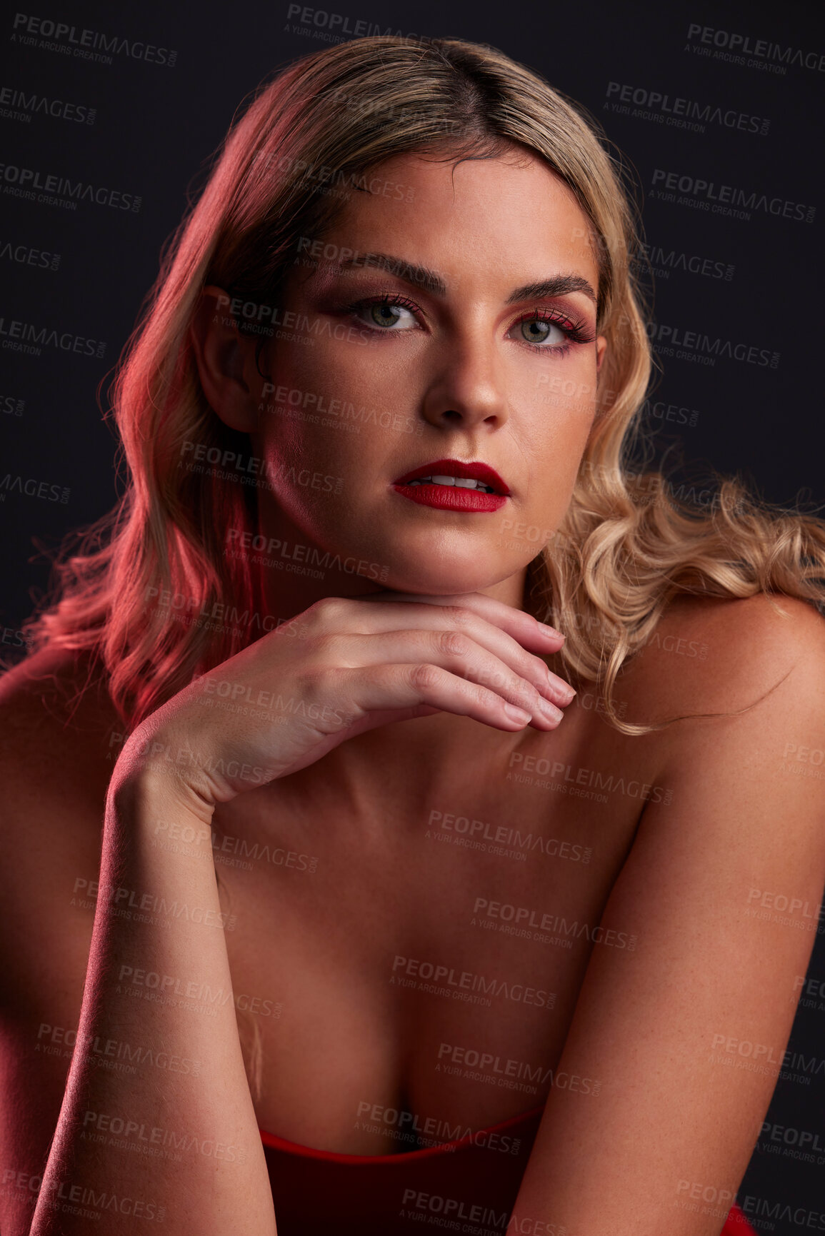 Buy stock photo Portrait, face and beauty with a woman in studio on a dark background in red lighting for desire. Skincare, makeup or cosmetics with a young female model posing for natural feminine confidence