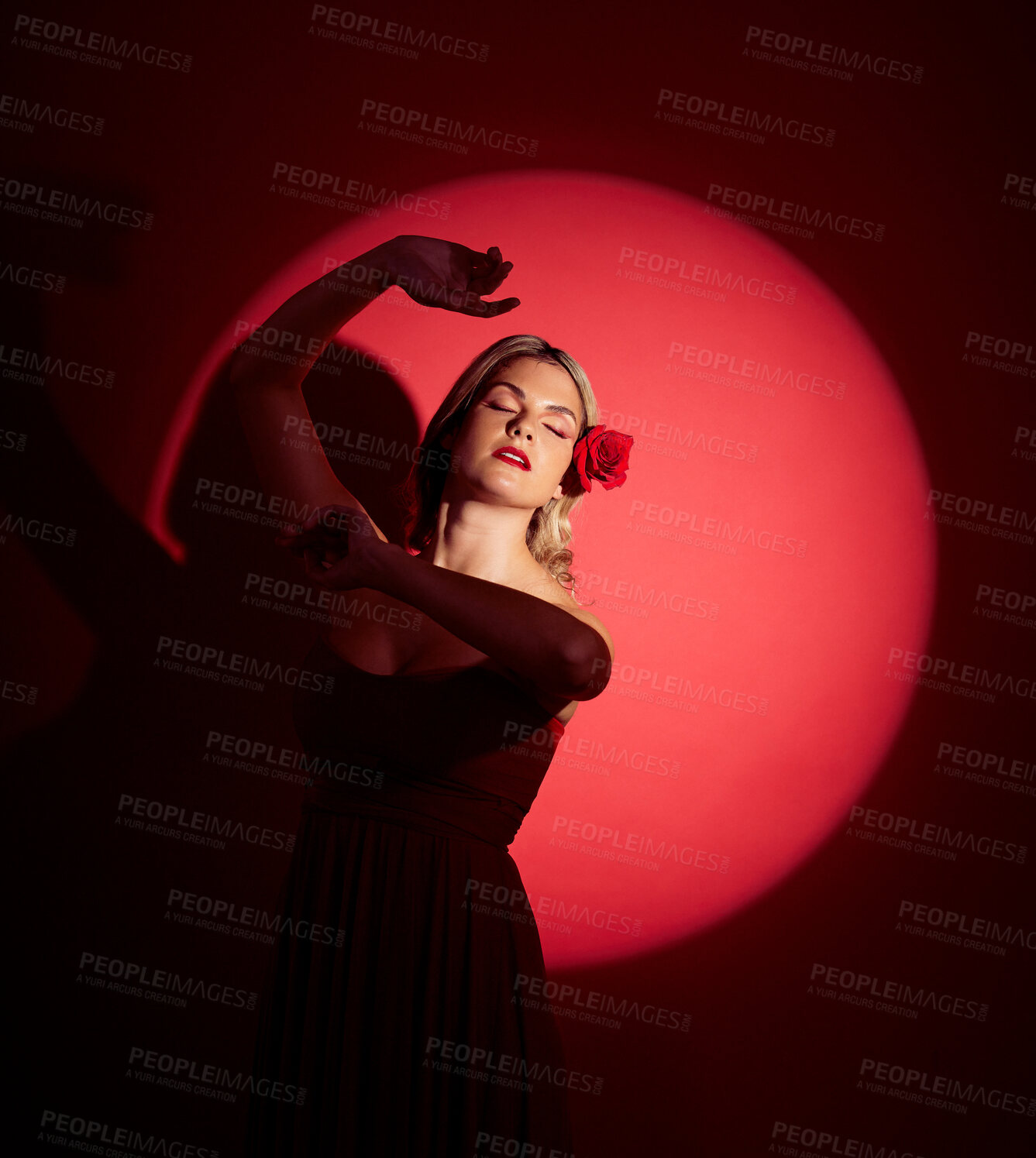 Buy stock photo Vintage, creative and a woman in a spotlight on a studio background for an art aesthetic. Fashion, retro and a young girl or rich model in a stylish dress or clothes isolated on a red backdrop