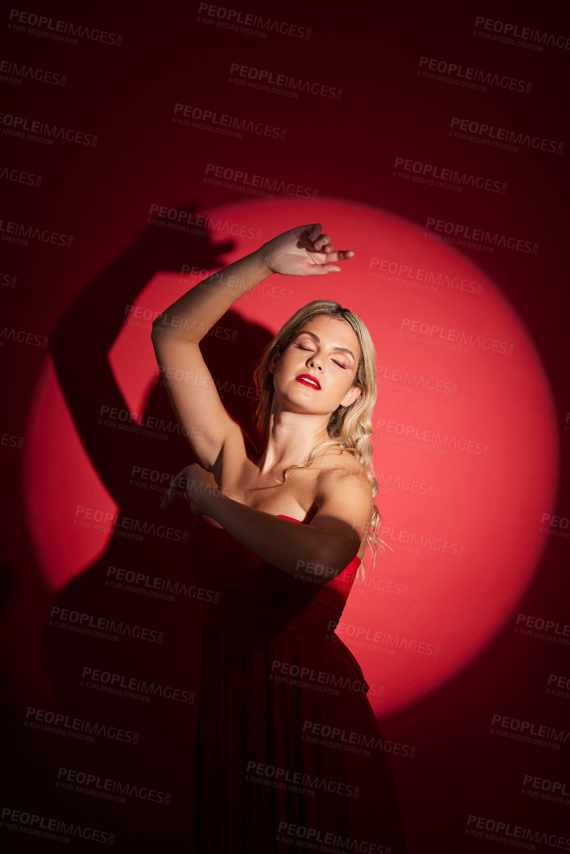Buy stock photo Vintage, fashion and a woman in a spotlight on a studio background for an art aesthetic. Creative, retro and a young girl or rich model in a stylish dress or clothes isolated on a red backdrop