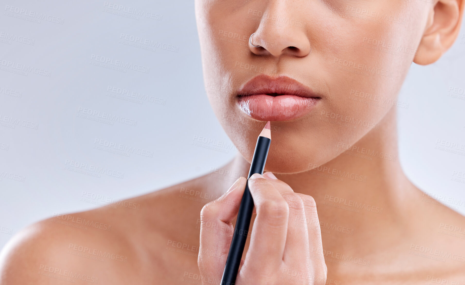 Buy stock photo Makeup, mouth and woman with lip pencil in studio for beauty, cosmetics and color on grey background. Liner, filling and hand of female model with beauty product for glamour, routine or application