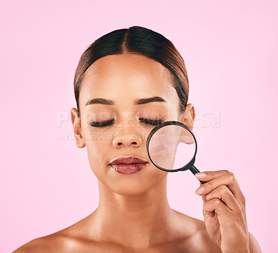 Buy stock photo Woman, face and magnifying glass, beauty and zoom in on pores, skincare and makeup isolated on pink background. Search, investigate and check skin with glow, female model and dermatology in studio