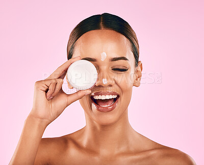 Buy stock photo Happy woman, cream in container and beauty, skincare and moisturizer dot on face on pink background. Natural cosmetics, self care and lotion, sunscreen and dermatology with female model in studio