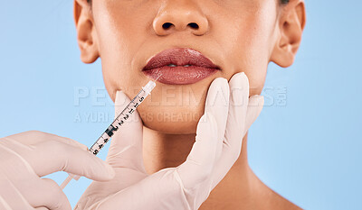 Lip filler, injection and beauty, woman and cosmetic surgery closeup and dermatology on blue background. Face, skincare and syringe, female model and doctor hands with liquid collagen in studio
